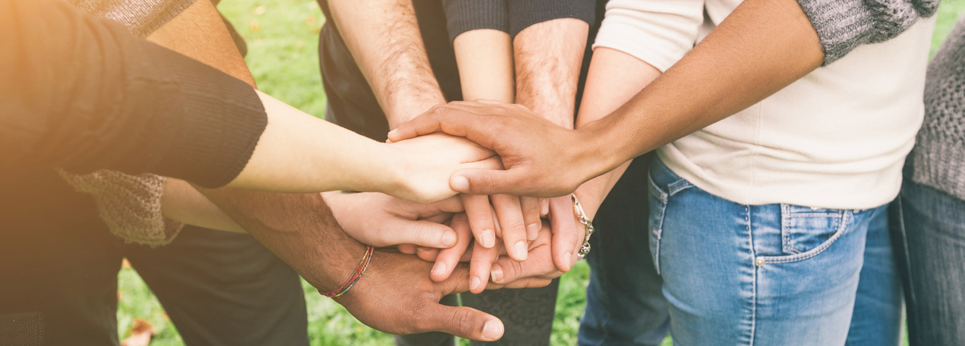 Friends grouped together holding hands