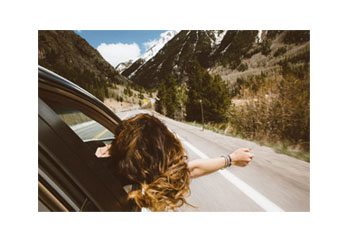 girl in car traveling on highway