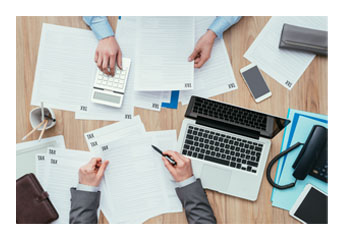 business people working on tax documents at a desk