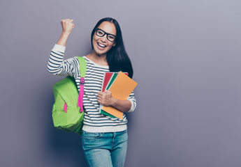excited college girl with book bag and books/folders