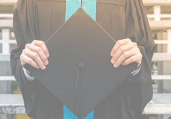 graduate holding graduation cap