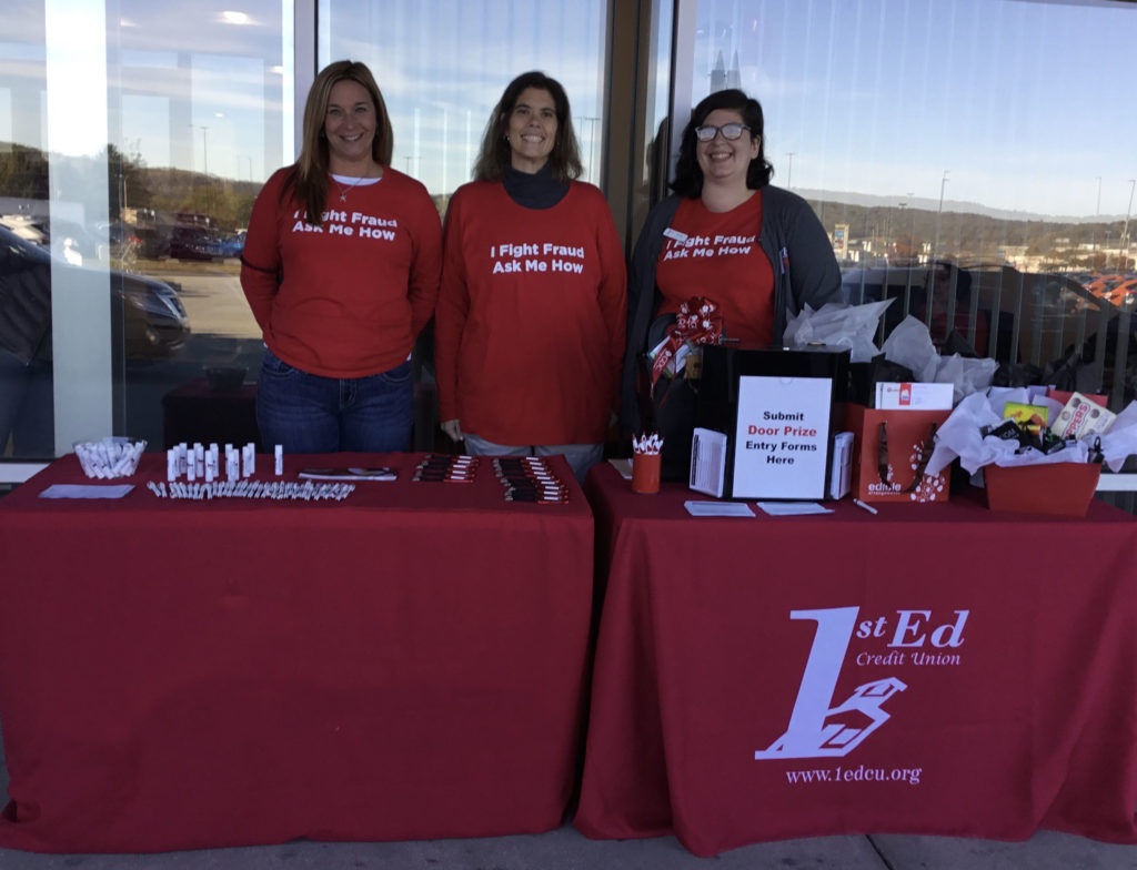 Hanover branch staff standing behind table of giveaways and doorprizes at Hanover Grand Opening