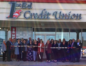 Hanover branch staff and community members gather for ribbon cutting of a ribbon with actual money