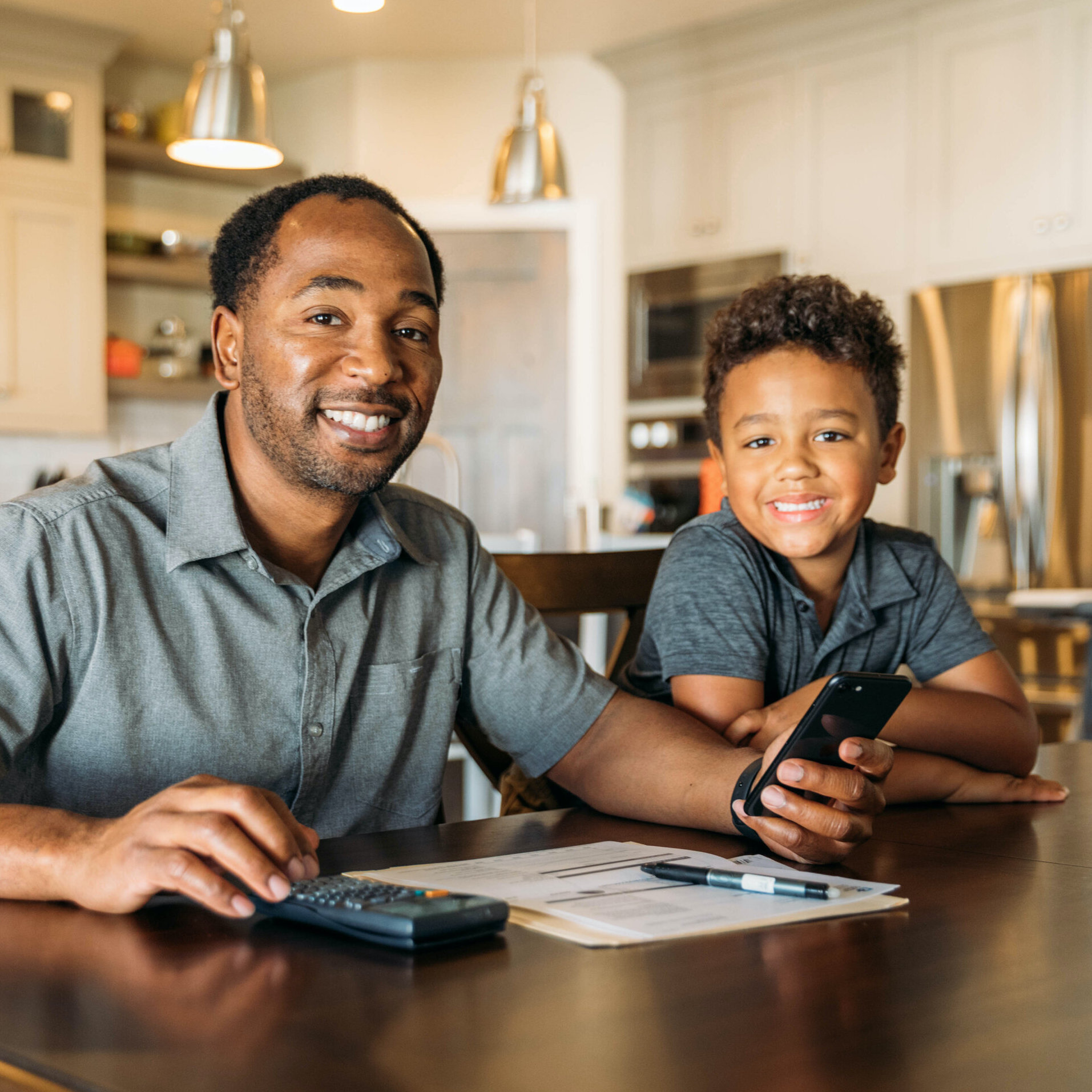 Father and son practicing calculations- money management for kids