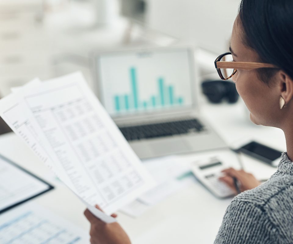 Person reviewing documents at desk