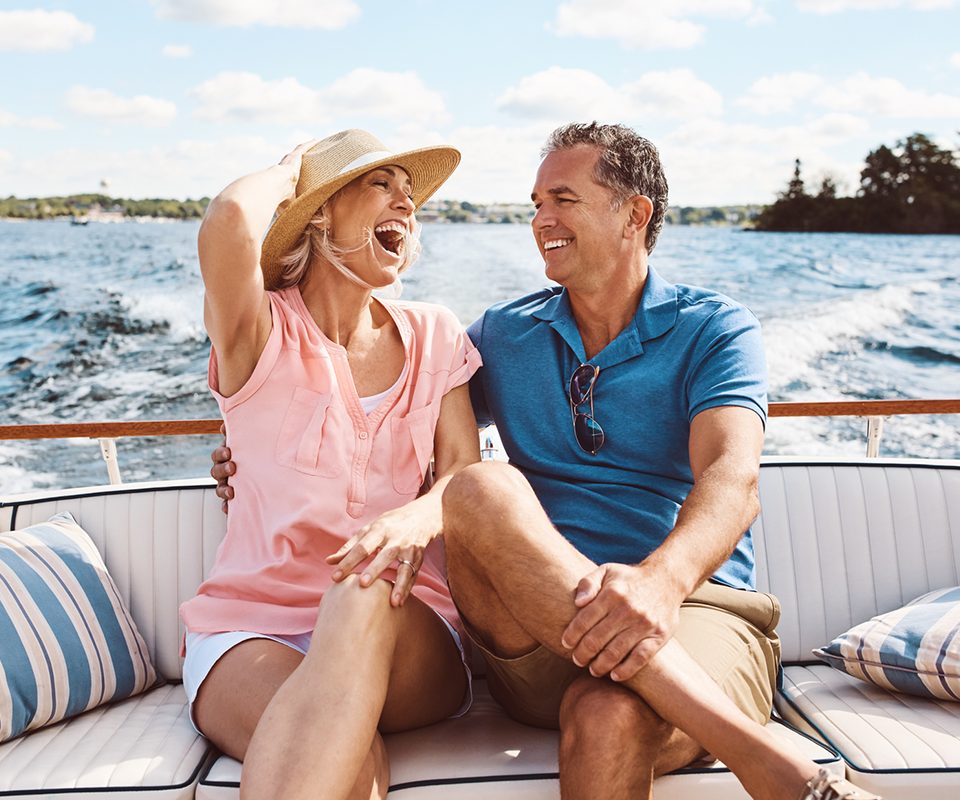 Happy couple enjoying boat ride on vacation