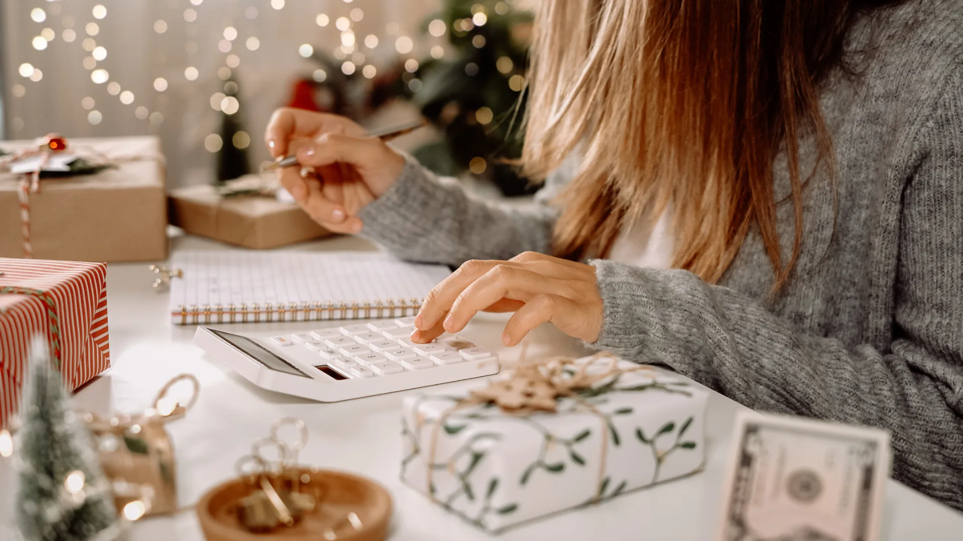 Person planning a holiday budget to track spending and save money