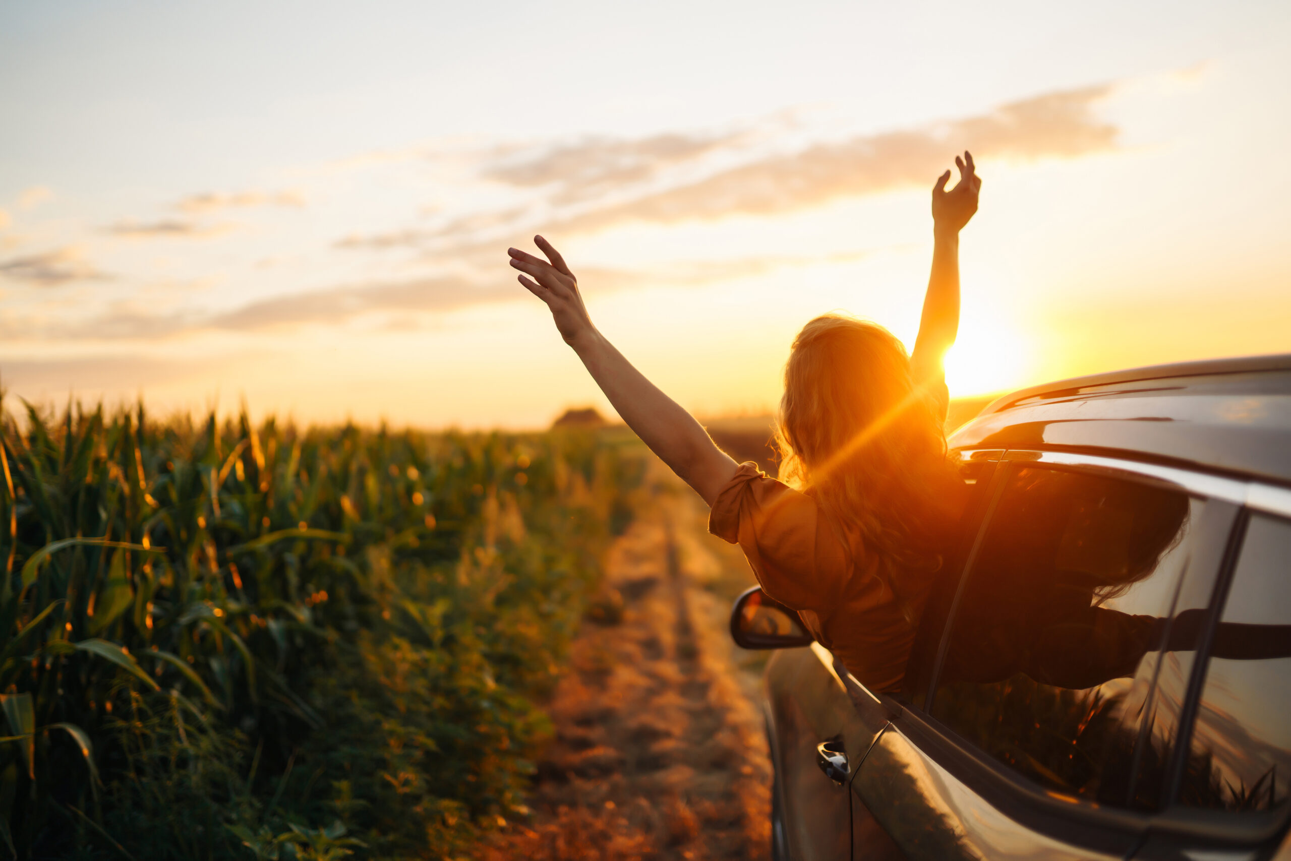 Happy woman on a summer road trip after saving with an Auto Loan at 1st Ed